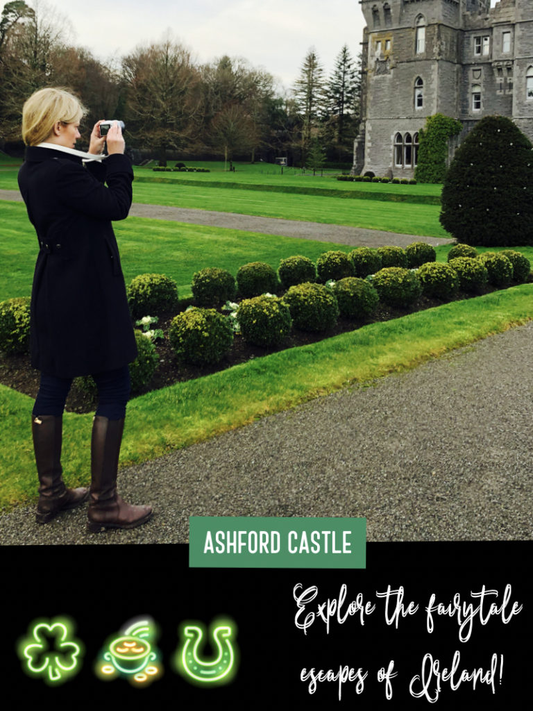 A blonde woman photographs Ashford Castle in Cong, Ireland.