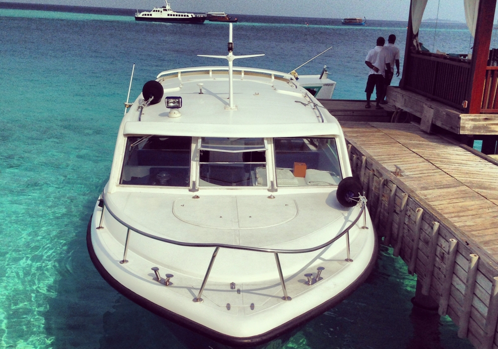 A speed boat docks in the Maldives.
