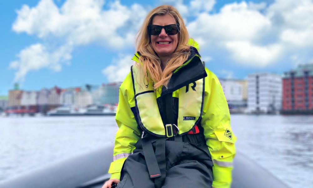 A blonde female takes a RIB boat trip in Bergen, Norway